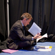 Treasury Secretary Timothy F. Geithner sits on the floor and reviews notes before President Barack Obama's press conference at the G20 Summit in Toronto, Canada.